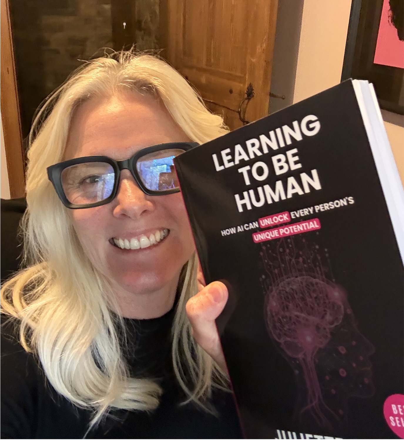 Juliette holding her book, Learning to be Human